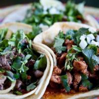 Soft Tacos Dinner Plate · Large tacos served on a soft corn tortillas with your choice of meat. Served with beans and ...