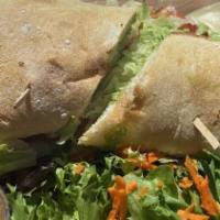 Portofino Sandwich · Grilled chicken breast, pesto sauce, Swiss cheese, lettuce and tomato, served on toasted cia...