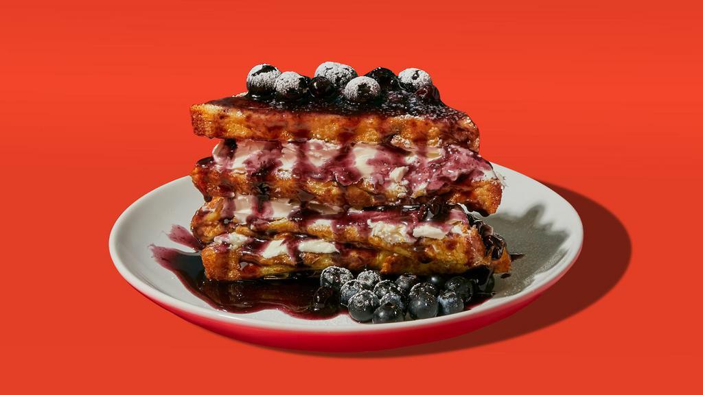 Blueberry Stuffed French Toast · Four slices of egg-washed french toast stuffed with cream cheese and blueberries and topped with maple syrup and butter.