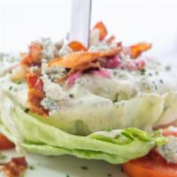 Wedge Salad · Iceberg lettuce, bleu cheese crumbles, honey-cured bacon, heirloom tomatoes, fried onion, cr...