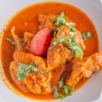 Chicken Curry · Classic curry of puréed onion, garlic, ginger, tomatoes, herbs, and spices. Served with rice.