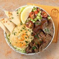 Beef And Lamb Gyro Hummus Bowl · Marinated beef and lamb over hummus, Greek salad, shredded green cabbage and a drizzle of ta...