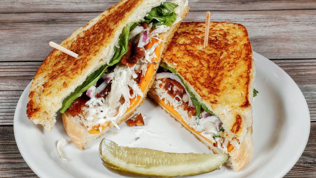 Turkey Club · Freshly baked turkey breast on French, cheddar cheese, bacon, red onions, ranch, and a romaine leaf.