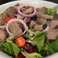 Steak Salad · Grilled flank steak, crisp greens, cherry tomato, red onion and gorgonzola, lime juice, sea-...