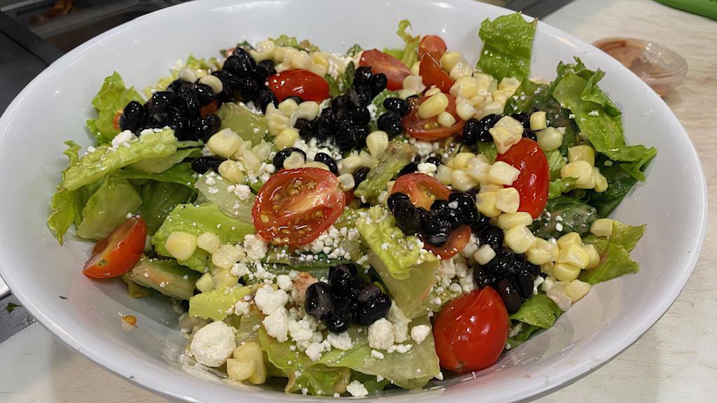 Baja Salad · Chopped Romaine, cherry tomato, diced avocado, diced red onion, white corn, black beans, Feta Crumbles, and BBQ or ranch sauce.