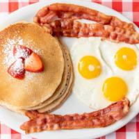 Pancakes Breakfast · Our delicious pancakes breakfast comes with three pancakes, three eggs, and a side of meat (...