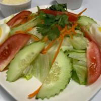 Green Salad · Spring mixed, lettuce, cucumber, shredded, carrots, onions, and tomatoes with peanut dressing.