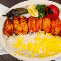 Boneless Chicken Kabob · Boneless chicken marinated, skewered and broiled. Served with fluffy rice and tomato.