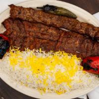 Soltani · A combination of chelo kabob and koobideh kabob. Served with fluffy rice and tomato.