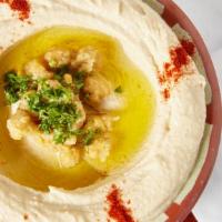 Hummus · Boiled and mashed chickpeas mixed with tahini, lemon and topped with olive oil, served with ...