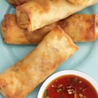 Crispy Egg Rolls · Six delicious golden fried vegetable spring rolls served with sweet chili sauce.
