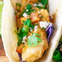 Crispy Baja Taco · Wild cod, cotija cheese, spicy baja sauce, citrus cabbage, pico de gallo.
