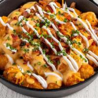 Loaded Tots · Bruxie Cheese Sauce, Applewood Smoked Bacon, Sour Cream, Chives