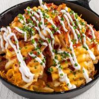 Loaded Waffle-Cut Fries · Bruxie Cheese Sauce, Applewood Smoked Bacon, Sour Cream, Chives