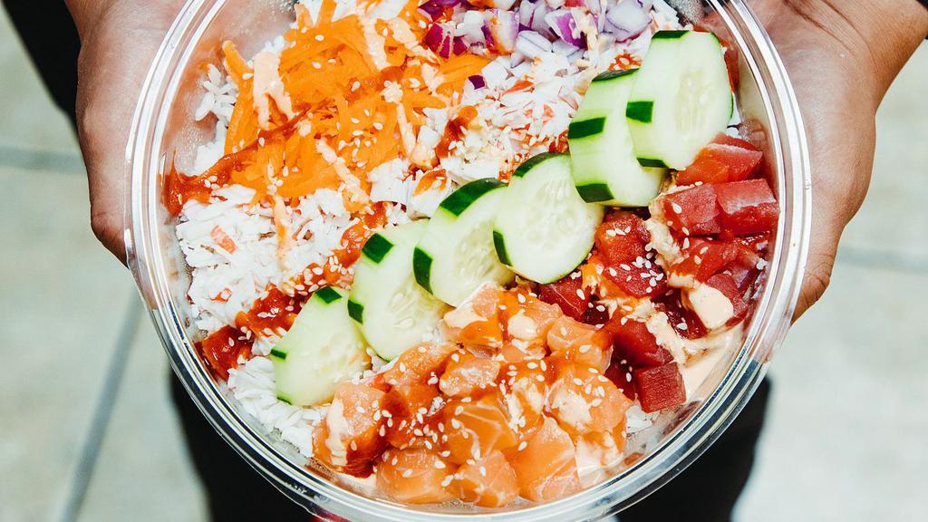 Blazing Poke Bowl · White Rice, Ahi Tuna, Salmon, Crabmeat, Cucumbers, Onions, Carrots, Sesame Seeds, Spicy Mayo & Sriracha