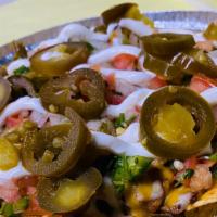 One- Meat Nachos · Corn Tortila Chips, Choice of Meat, Beans, Cheddar Cheese, Sour Cream, Pico De Gallo and Jal...