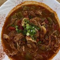 Jambalaya  · Slow-smoked chicken, andouille sausage and shrimp sautéed in a picante tomato sauce with cel...