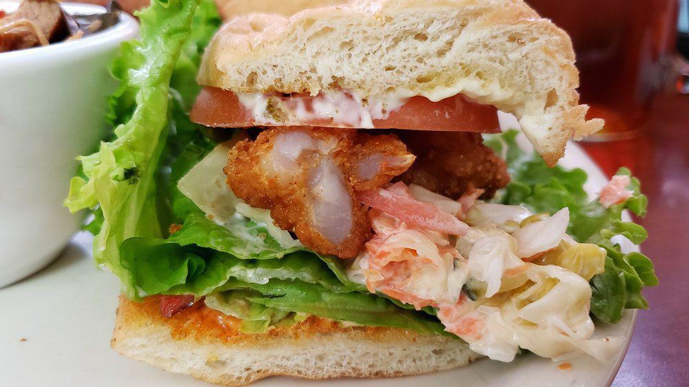 Po'Boy Sandwich · Your choice of fried catfish, fried shrimp or fried chicken served on a soft french roll with lettuce, vine-ripened diced tomatoes, coleslaw smoky jalapeño tartar sauce and spicy remoulade.