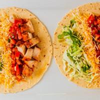 Dos Tacos Grande · Two tacos, flour or corn, pico de gallo salsa, lettuce, cheese, and fire grilled charo sauce.