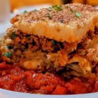 Greek Moussaka · Baked layers of eggplant, tomatoes, ground meat, potatoes, topped with bechamel and permesan.