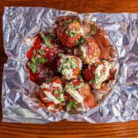 Oven-Baked Meatballs · Hearty meatballs topped with flippin' pizza sauce and fresh ricotta. Oven-roasted then toppe...