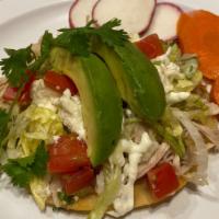 Tostada · Served with your choice of meat, refried beans, lettuce, tomato, avocado, sour cream, queso ...