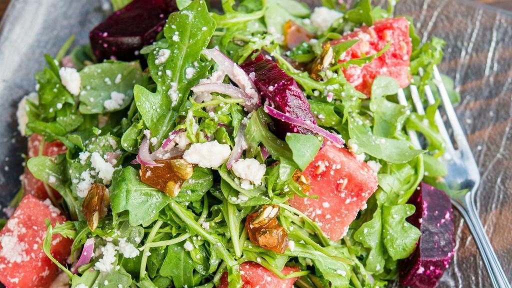 Beet & Watermelon Salad · earthy, roasted beets & sweet watermelon cubes tossed with peppery arugula & red onion, a citrusy vinaigrette & bits of creamy queso fresco & pepita ‘brittle’