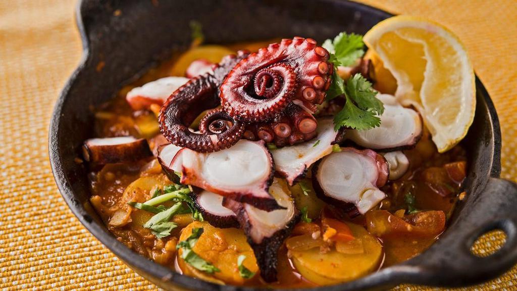 Spanish Octopus · tender octopus, grilled & sliced, served on fingerling potatoes sauteed with chorizo, garlic, smoked Spanish paprika, tomato, green olives, white wine & lemon