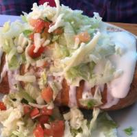 Chimichanga  · deep fried flour tortilla with refried beans , cheese and meat inside. With a side of sour c...