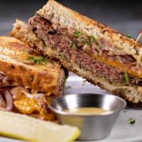 Veggie Burger Patty Melt · Impossible patty, vegan sharp cheddar, dijon grilled onion, and pickles on rye bread, served...
