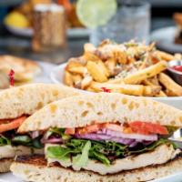 Grilled Chicken Sandwich · Herb-marinated chicken breast, greens, tomato, onions, and pickles on a french roll, served ...