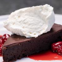 Flourless Chocolate Cake · Vanilla whipped cream and tart cherry compote