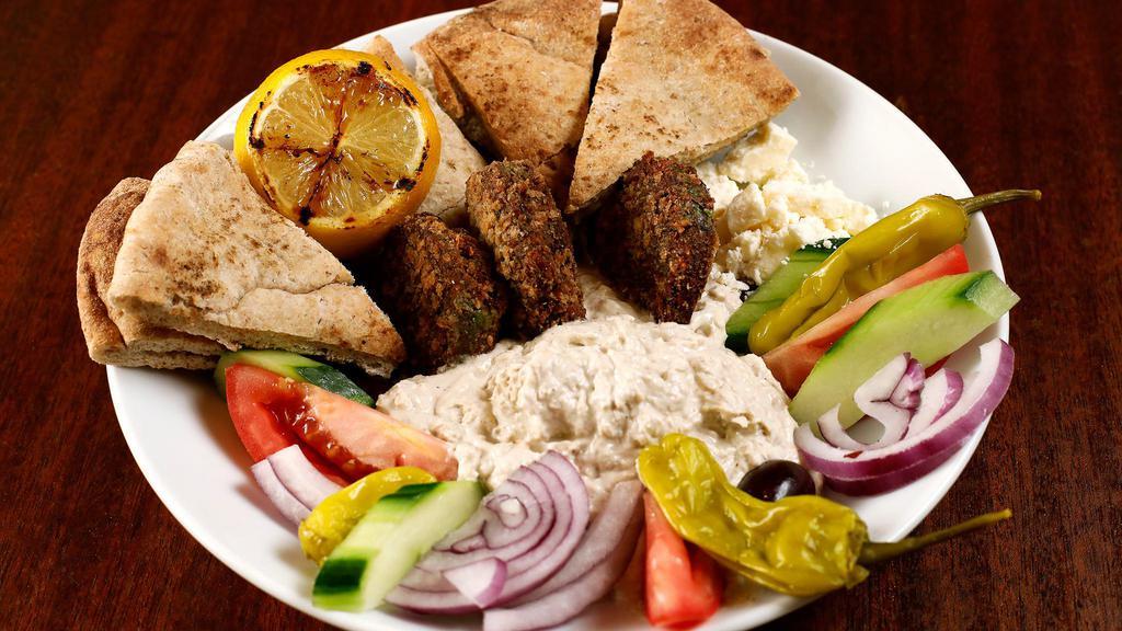 Mediterranean Plate · Vegetarian. Hummus, feta cheese, tomato, kalamata olives, onion, cucumbers, pepperoncini, housemade falafel, grilled lemon, pita bread.