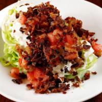 Wedge Salad · Iceberg wedge, hard boiled egg, tomato, bacon, blue cheese crumbles,  and blue cheese dressi...