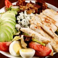 Cobb Chicken Salad · Baby green mix, grilled chicken, bacon, egg, avocado, crumbled blue cheese and tomato with y...