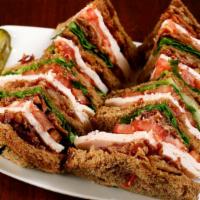 Turkey Club · 100% all-natural turkey breast, bacon, lettuce, and tomato on whole wheat toast.