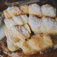 Cañoncitos · A dozen Cañoncitos. Flaky pastry filled with dulce de leche.