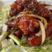 Tamarind Wings · Lightly battered, jalapeño, onions tossed in tamarind sauce.