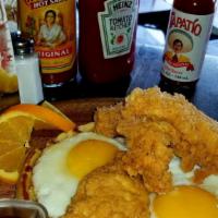 California Chicken & Waffle · Belgium Waffle topped with sunny side up eggs & golden chicken tenders.