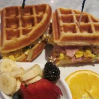 Waffle Egg Sandwich · Scrambled eggs with mushrooms, tomatoes, green onions, Canadian bacon, goat cheese & fresh b...