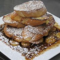 Cinnamon Kiss · A tower of sliced French baguette dipped in a brandy egg batter, golden brown, glazed in sug...