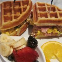 Waffle Egg Sandwich · Scrambled eggs with mushrooms, tomatoes, green onions, Canadian bacon, goat cheese and fresh...