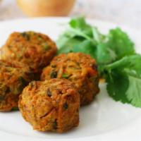 Pakora Vegetables · Delicious onions, cauliflower, potatoes and spinach coated in garbanzo batter and deep fried.