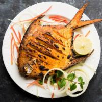 Tandoori Fish · Amazing fish that has been marinated in yogurt with spices served on a fresh bed of onions.