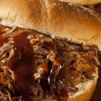 Pulled Pork Dinner · Delicious tender pulled pork. Comes with two sides. Greens, mac and cheese, smoked baked bea...