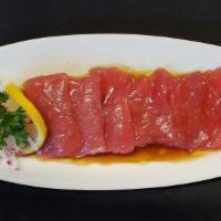 Crudo · Sashimi style sliced salmon or bluefin tuna with ponzu ginger dressing.
