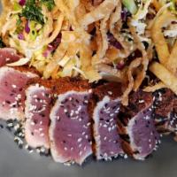 Asian Seared Tuna Salad · Seared tuna with baby kale, spring mixed greens, carrots and a ginger sesame dressing.