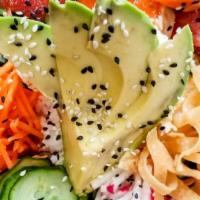Poke Bowl · Mixed spicy marinated sashimi over rice and top with cucumbers, carrots, wonton chips, edama...