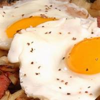 Corned Beef Hash And Eggs · Always a favorite. Topped with three poached eggs and toast.