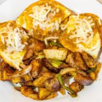 Huevo Rancheros · A classic mexican dish of eggs served on top of tortillas and smothered with fresh homemade ...